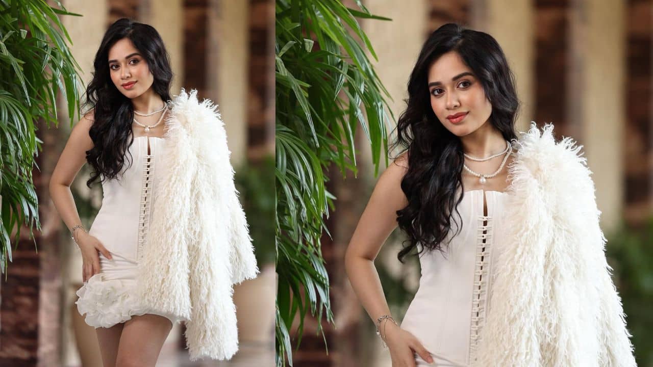 Statement maker  Jannat stuns in this chic white mini dress featuring floral detailing at the hem and a bold lace-up front. Paired with a statement pearl necklace and a fluffy white jacket, the look is modern, edgy, and fashion-forward. Her confidence elevates the outfit, making her look nothing less than a diva.