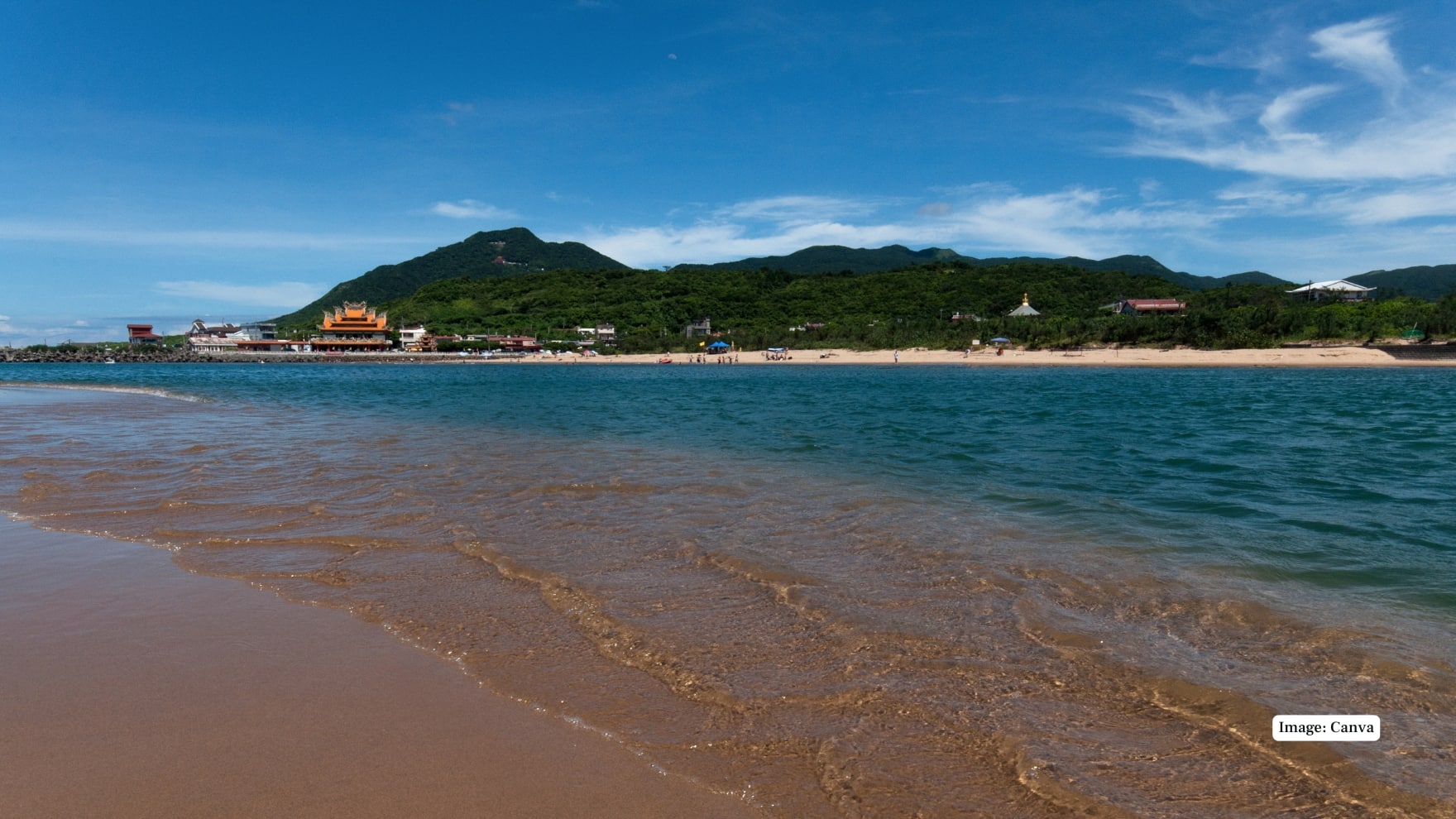 Fulong Beach - Taiwan Famous for its lengthy golden coastline and exceptionally blue water in summer periods. Vibrant beach with music festivals, water sports and picturesque trails in the area. (Image: Canva)