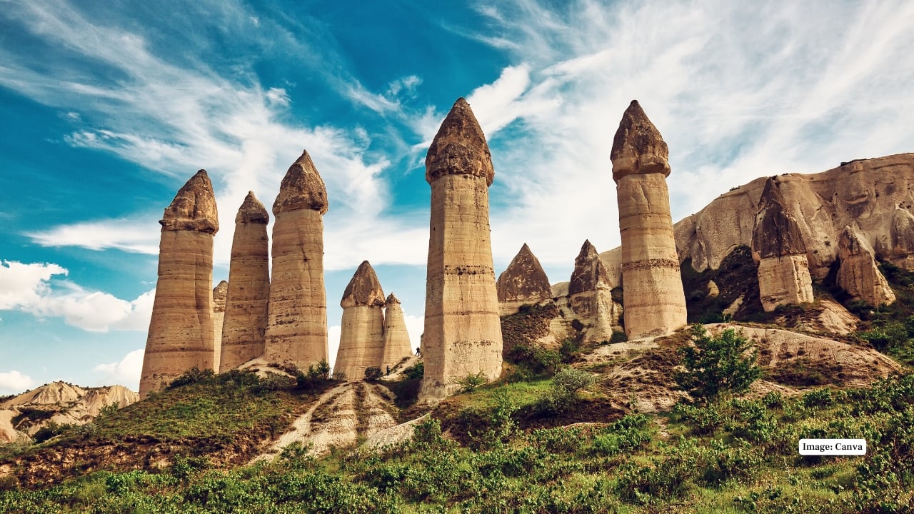 6. Cappadocia, Turkey: Fairy Chimneys The shape of cone-like rocks gives an illusion of a fantasy landscape. Hot air balloons suspended in the air at sunrise beautify the surrealist scene, and the region appears to have turned into an animated film. (Image: Canva)