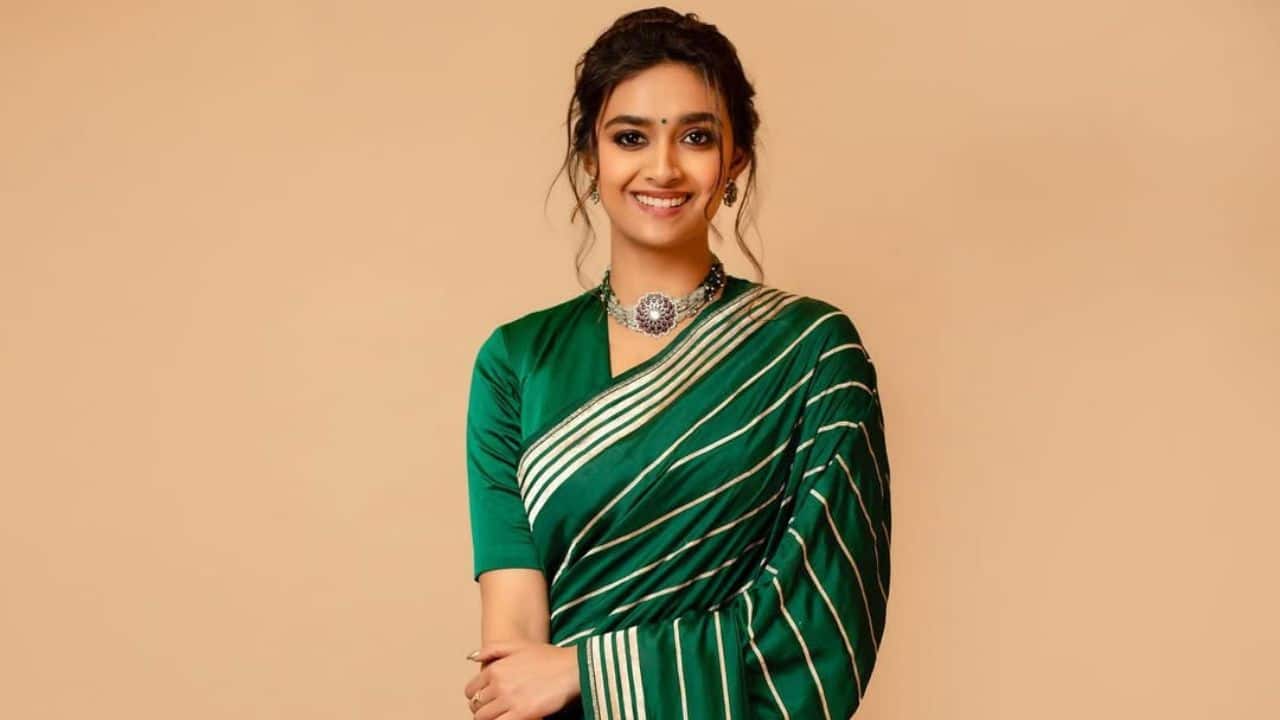 Keerthy embraces Navratri green. Keerthy wore a plain green saree with a single golden stripe and a matching golden border for a classic and stylish look. She completed it with a black bindi, a silver necklace, with a traditional hairstyle, and a half-sleeve blouse.