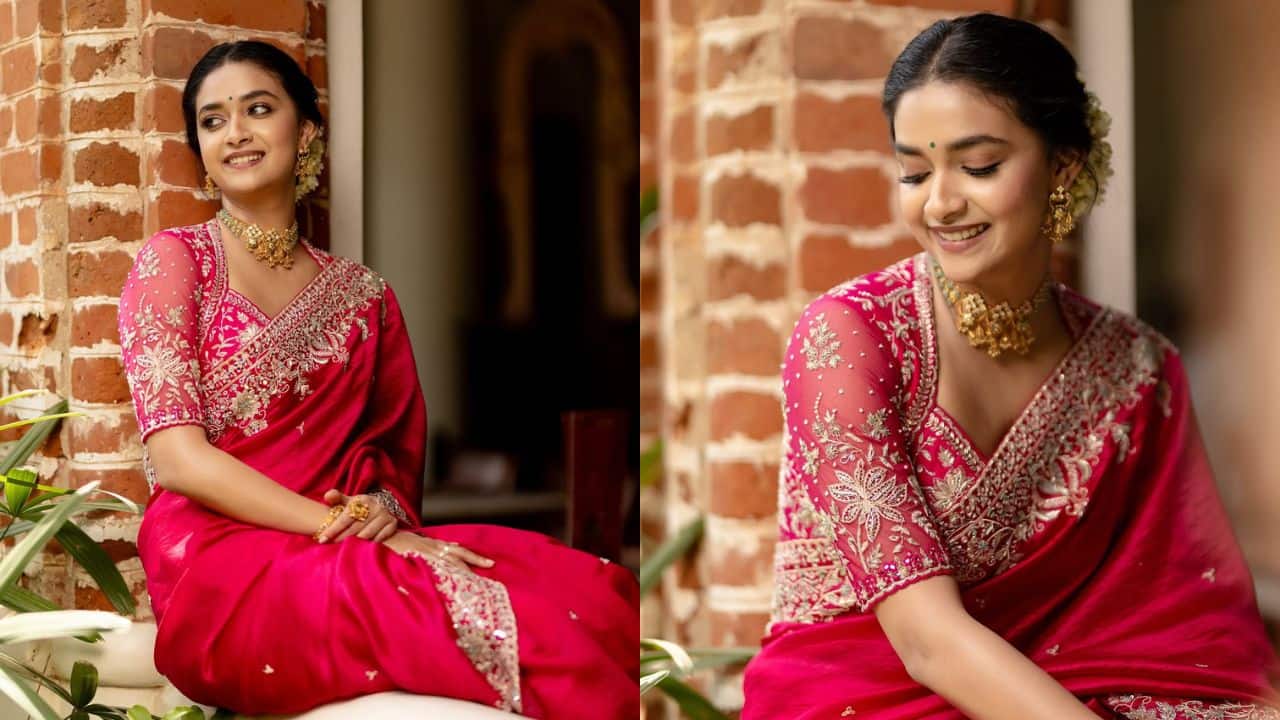 Keerthy’s red ethnic look radiates festive energy Dress to impress in a gorgeous red silk saree with beautifully worked borders and golden decorations, just like Keerthy Suresh. Complete the goddess-like ensemble with a golden necklace, bold jhumkas, and a tidy bun wrapped in a gajra. Pairing it with a V-neck blouse that is heavily decorated.