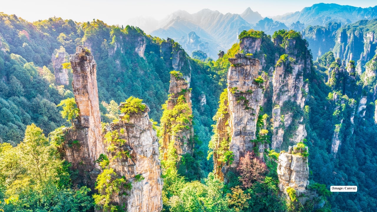3. Zhangjiajie National Forest Park, China – Mountains That Float Towering sandstone pillars rise from misty forests, inspiring the floating mountains in Avatar. Walk the Glass Bridge over Zhangjiajie Grand Canyon, hike through dense pine forests, or take a cable car to Tianzi Mountain for panoramic views that feel suspended between reality and fantasy.
