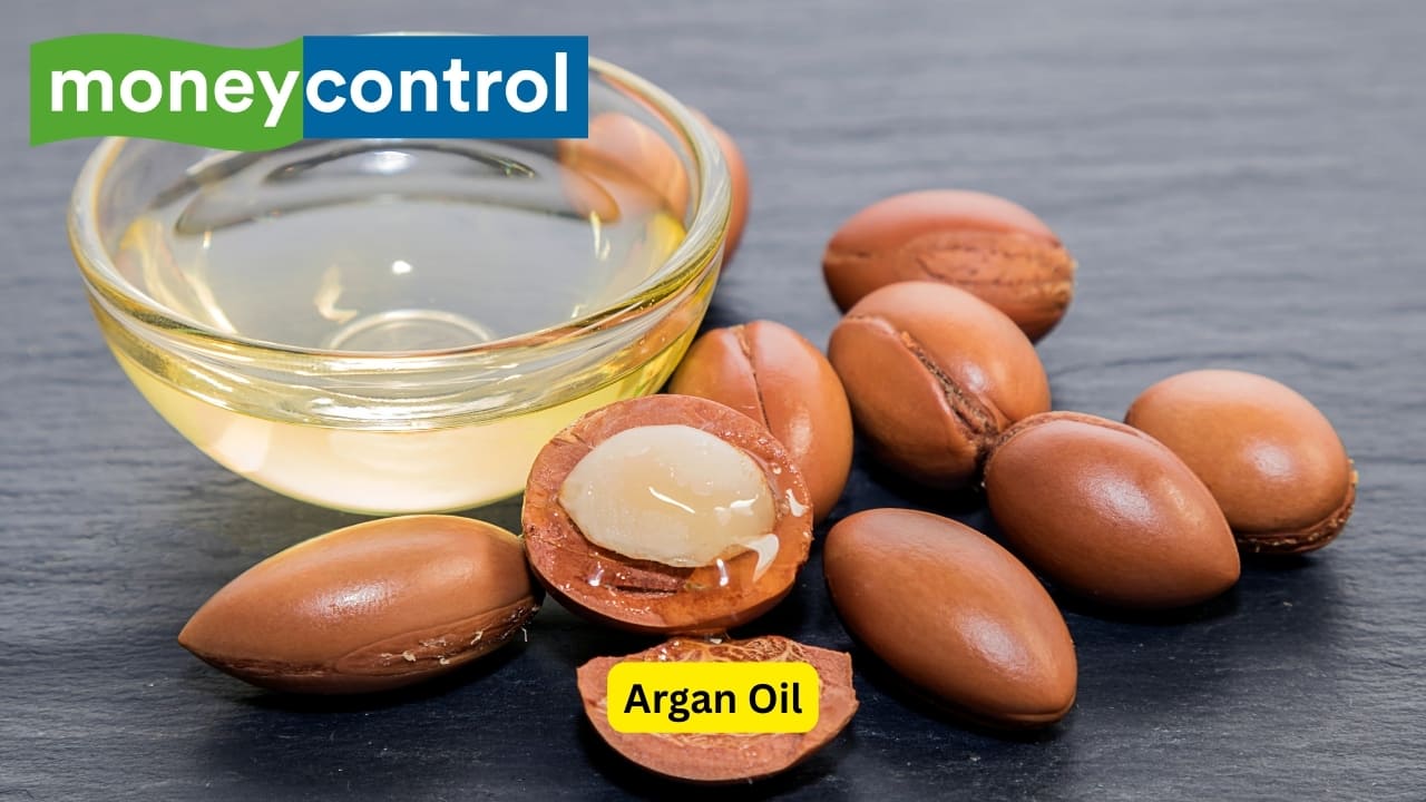 Argan Oil Argan oil, occasionally referred to as &quot;liquid gold,&quot; is derived from the kernels of the Moroccan argan tree. It is rich in antioxidants, vitamin E and essential fatty acids that nourish dry, brittle hair. Argan oil serves to tame frizzy hair, protects hair from heat damage, and improves elasticity. While it may not increase hair growth rate, it creates a healthy environment that is optimal for healthy hair by improving the condition of the overall hair and scalp. (Image: Canva)
