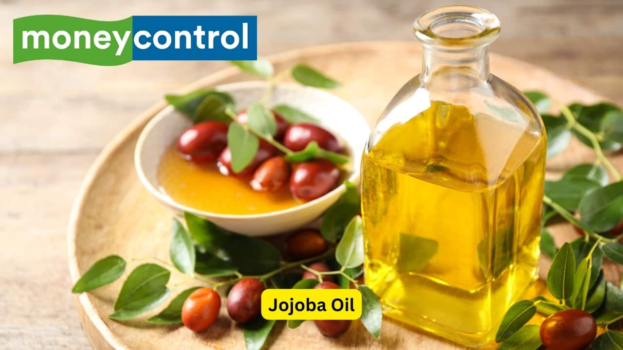 Jojoba Oil Jojoba oil is unique because its chemical structure is incredibly similar to the sebum produced on your scalp. This allows jojoba oil to be very effective without clogging your pores and strands. Jojoba oil is full of vitamins B, C, and E as well as the minerals zinc and copper, which help contribute to healthy hair. Jojoba oil helps dissolve products that accumulate on the scalp, normalizes oil production on the scalp, and strengthens hair from the root. (Image: Canva)