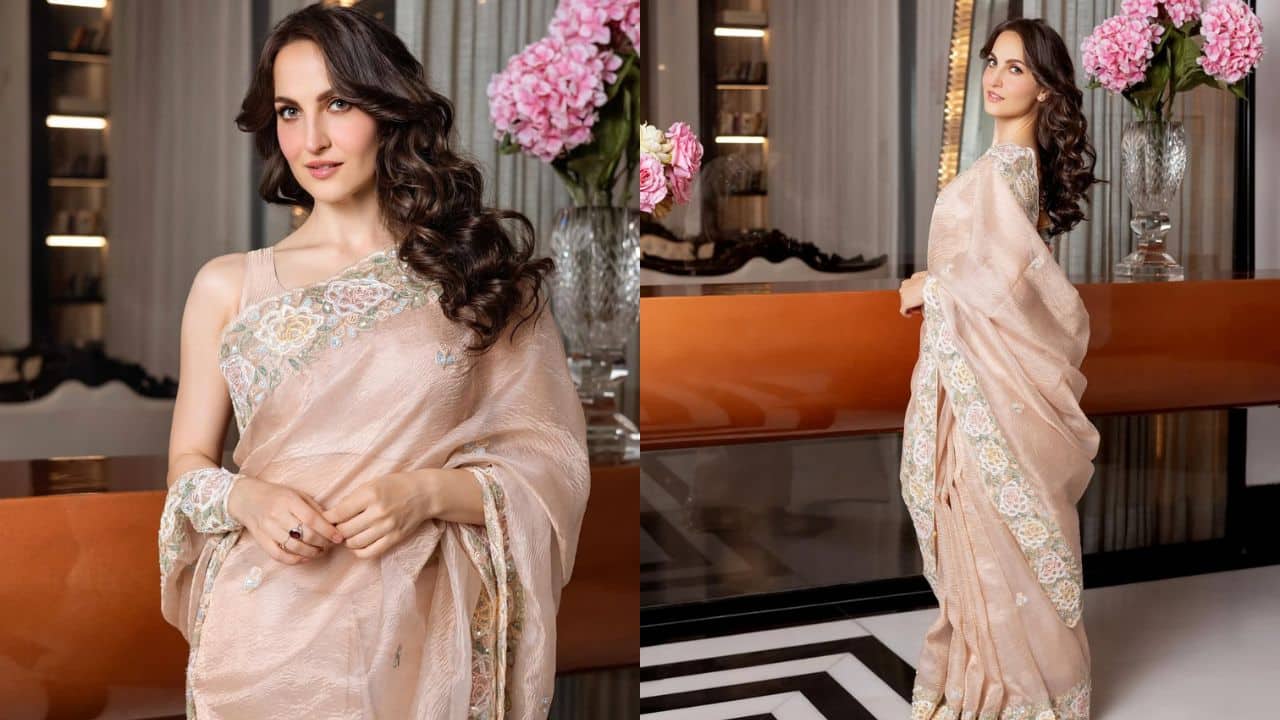 Peach-pink elegance Actress Elli AvrRam displays elegant style wearing a stunning, light peach-pink saree. The fabric's classic appeal is enhanced by delicate, elegant embroidery in pastel colors along the borders. The actress completes the classic style with minimal jewelry and soft, full curls. Peach-pink elegance Actress Elli AvrRam displays elegant style wearing a stunning, light peach-pink saree. The fabric's classic appeal is enhanced by delicate, elegant embroidery in pastel colors along the borders. The actress completes the classic style with minimal jewelry and soft, full curls.