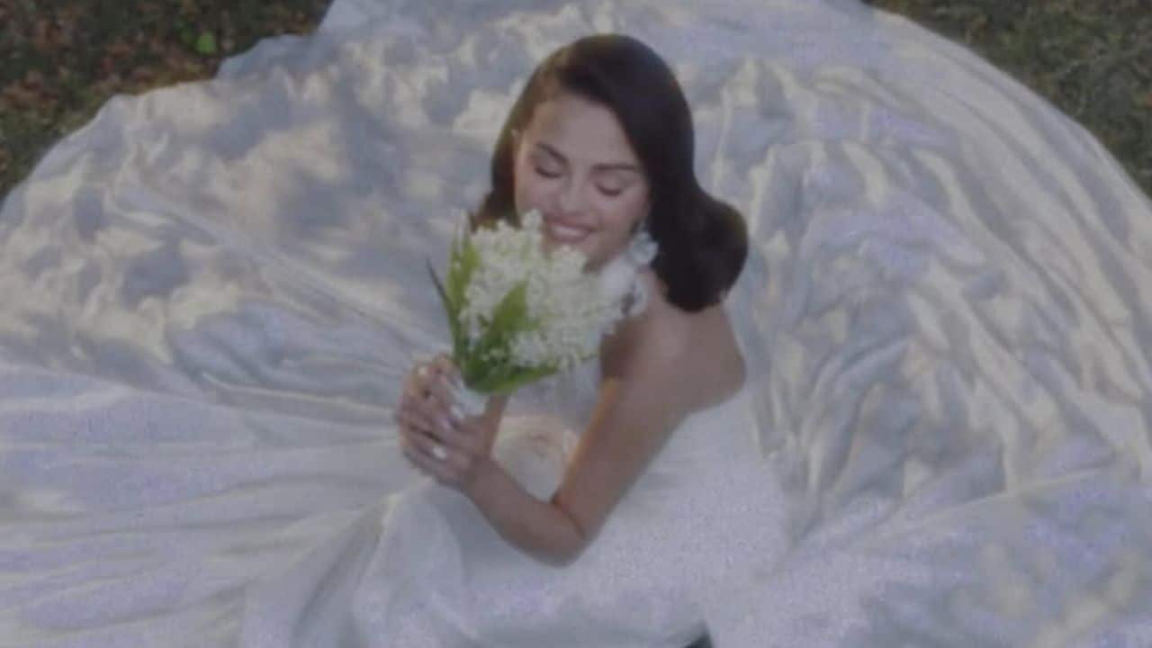 Selena Gomez's wedding gown For the wedding, Selena and Benny sported Ralph Lauren. The singer and actress wore a custom hand-draped halter-neck satin dress with embroidery and a bouquet of lily of the valley. She completed her look with platinum-and-diamond earrings by Tiffany & Co. Benny complimented the bride in a classic black tuxedo and bow tie. Selena Gomez's wedding gown For the wedding, Selena and Benny sported Ralph Lauren. The singer and actress wore a custom hand-draped halter-neck satin dress with embroidery and a bouquet of lily of the valley. She completed her look with platinum-and-diamond earrings by Tiffany & Co. Benny complimented the bride in a classic black tuxedo and bow tie.