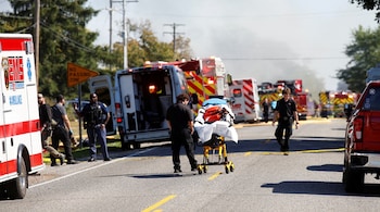 Emergency personnel work at the scene of a shooting which took place at the Church of Jesus Christ of Latter-day Saints, according to police, in Grand Blanc, Michigan, U.S., September 28, 2025. REUTERS/Rebecca Cook