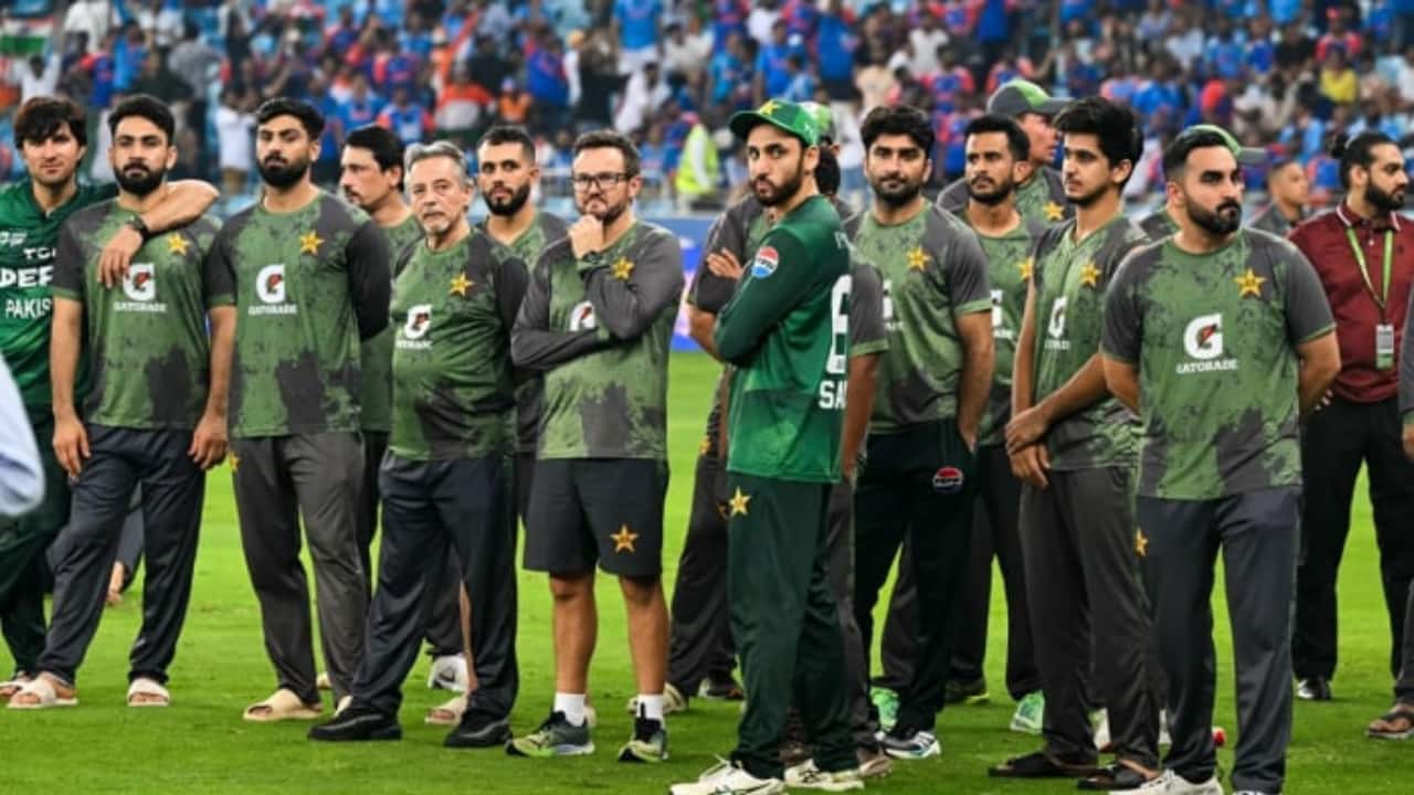 The ceremony was delayed for over an hour, with Indian players standing on the field, refusing to budge toward the dais. When it was clear that a traditional handover wouldn’t happen, organizers removed the trophy from the ground. (AFP Image)