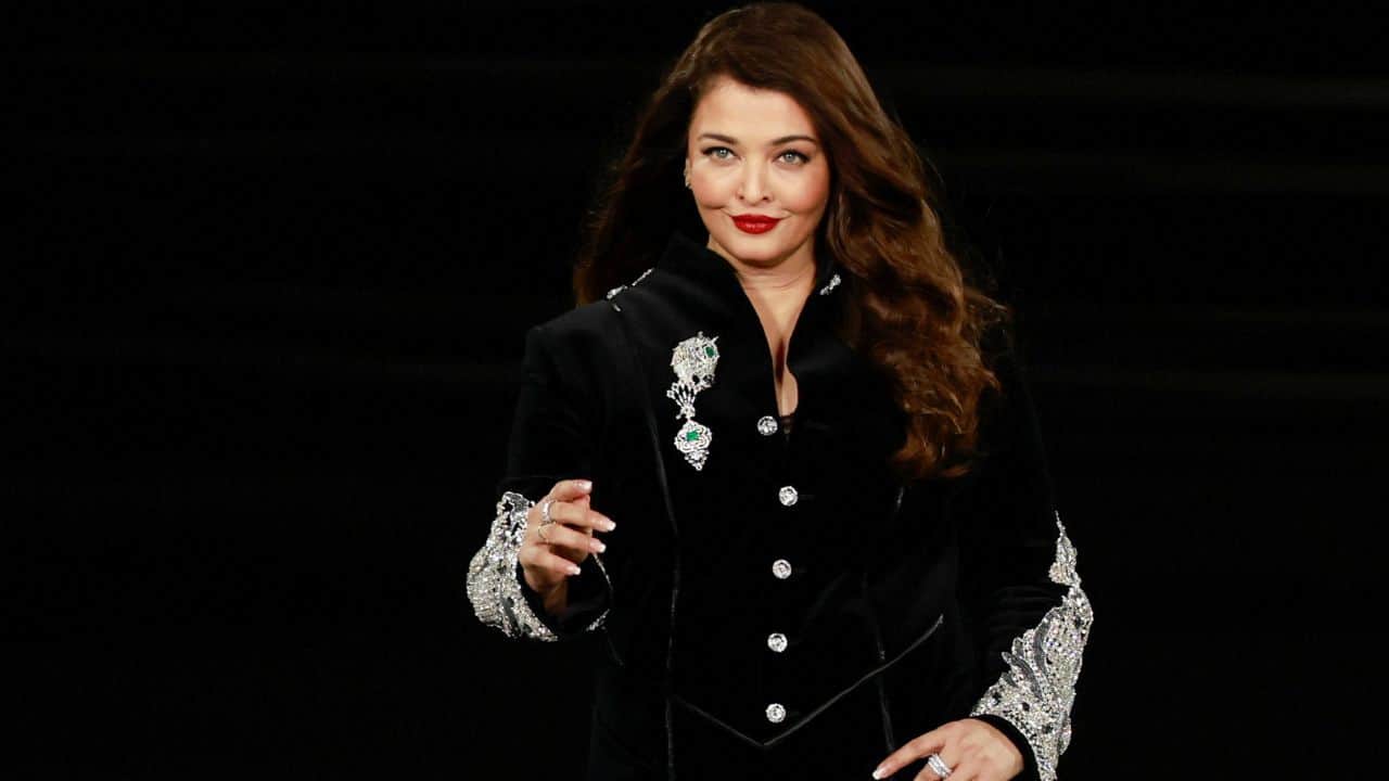 Accessories Aishwarya Rai accessorised her look with bold diamond rings, delicate diamond ear studs, and high heels. Her signature style of leaving her hair loose and parted on one side gave the ensemble's architectural boldness a romantic touch. She looked even more glitzy thanks to the feathered brows, delicate pink eyeshadow, sleek eyeliner, bold red lips, and flushed and contoured cheeks.