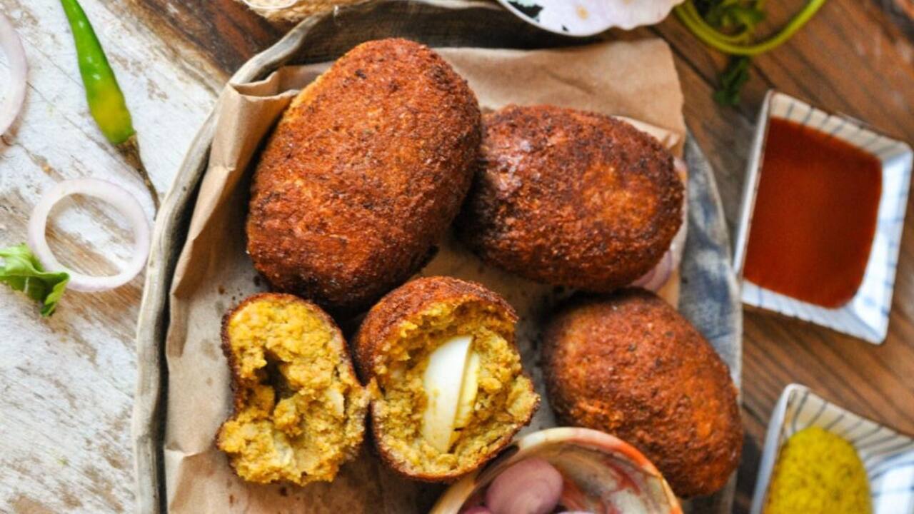 Dim'er devil Dim'er Devil is the Bengali version of Scotch eggs; boiled eggs are taken and wrapped in a spicy mixture of meat and potatoes, then wrapped in breadcrumbs and fried. It is hearty, filling, and so flavourful and satisfying. The sinfulness of a soft egg yolk that oozes out bites into the warm crunchy, spicy mixture just makes it the ultimate snack.(Image: Pinterest)