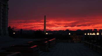 A view of the sun setting behind the Washington Monument on September 29, 2025 in Washington, DC.