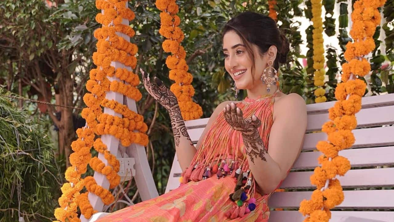 Glowing at the Festivities During her sister's pre-wedding celebrations, Shivangi Joshi shows her gorgeous mehndi design while sitting on a swing. She looks beautiful and joyful while wearing a lovely orange outfit. Shivangi’s beautiful jewellery and radiant smile perfectly captured the joyous atmosphere of the special occasion Glowing at the Festivities During her sister's pre-wedding celebrations, Shivangi Joshi shows her gorgeous mehndi design while sitting on a swing. She looks beautiful and joyful while wearing a lovely orange outfit. Shivangi’s beautiful jewellery and radiant smile perfectly captured the joyous atmosphere of the special occasion