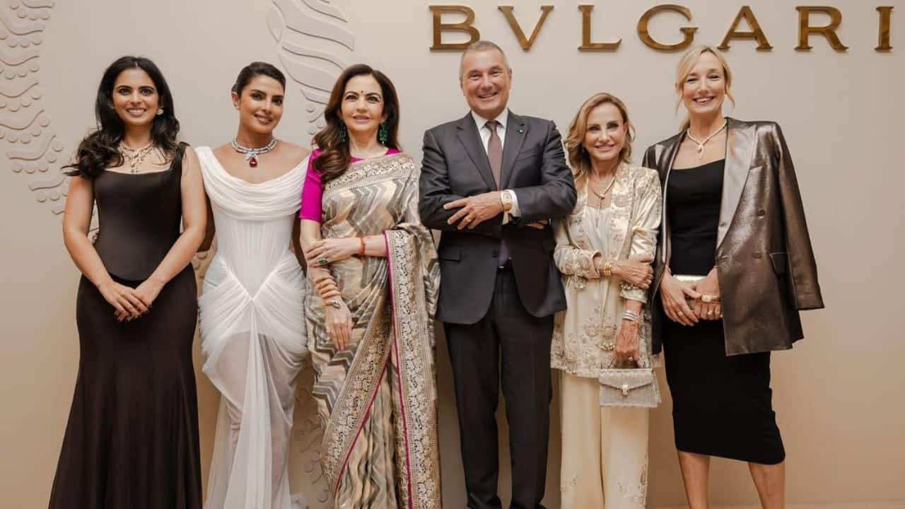 Gathering of Dignitaries The actress wearing a white gown posed against a Bvlgari logo backdrop along with notable individuals at the event including the Group CEO Jean Christophe Babin and other individuals including the Founder &amp; Chairperson of Nita Mukesh Ambani Cultural Centre (NMACC), Nita Ambani and her daughter Isha Ambani.
