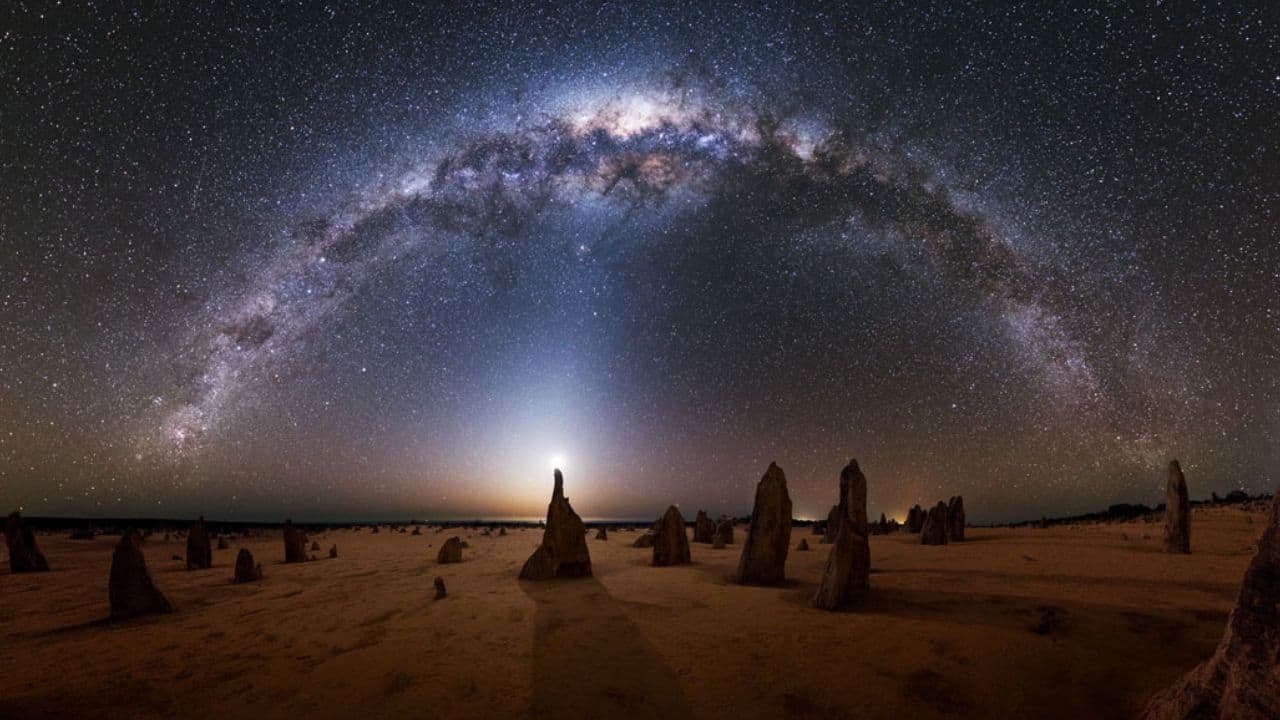 Milky Way over the Australian Pinnacles: A stunning panorama captures Australia’s Pinnacles beneath a crescent Moon, zodiacal light, and the glowing Milky Way, revealing a surreal blend of Earth’s beauty and cosmic wonders. (Image: Michael Goh/NASA)