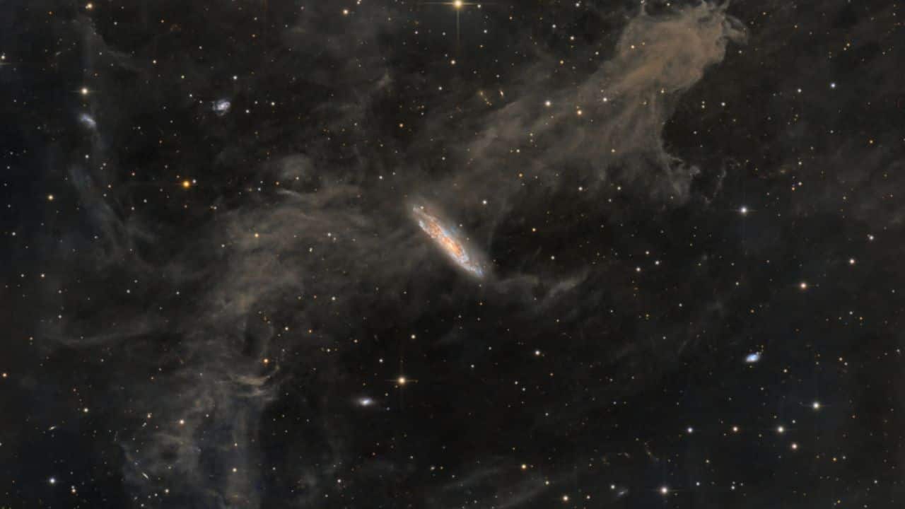 Galaxies, Stars and Dust: Galactic cirrus clouds reflect the Milky Way’s starlight in Pegasus, while spiral galaxy NGC 7497 glows 60 million light-years away, mirroring our galaxy’s dust and star patterns. (Image: NASA)