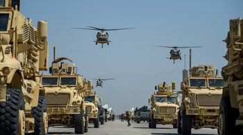 Taliban military helicopters fly to celebrate the third anniversary of Taliban's takeover of Afghanistan, at the Bagram Air Base, in Bagram, Parwan province on August 14, 2024.