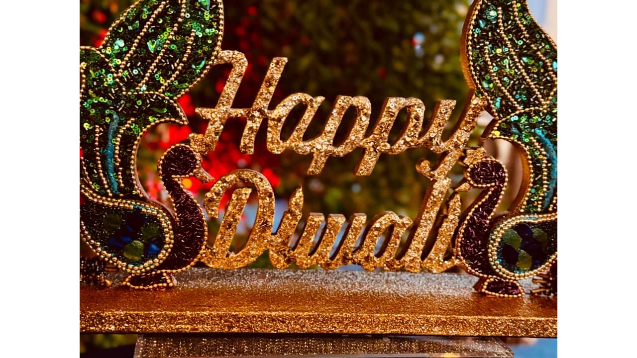 Diwali family celebration portrait  Generate a realistic 4K portrait of a multigenerational Indian family celebrating Diwali at home. Grandparents, parents, and children are dressed in traditional attire, such as sarees, lehengas, kurtas, and sherwanis, with vibrant colours. The living room is decorated with marigold garlands, diyas, and fairy lights. Everyone should be smiling and interacting naturally, illuminated by soft golden lighting. Faces should remain true to the original photos, with a slightly blurred background to emphasise the family.