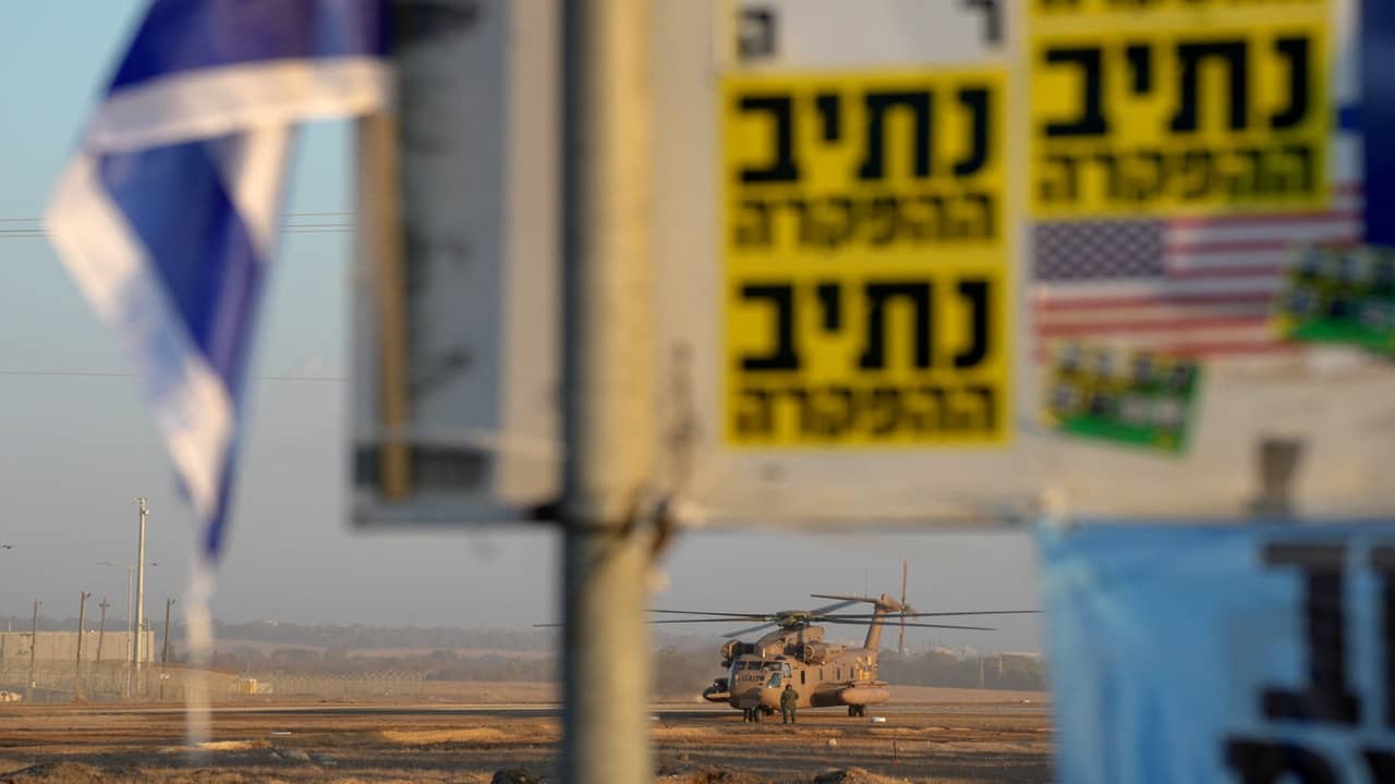 An Israeli military helicopter waits in preparation to take hostages released by Hamas in Gaza to hospitals in Israel after they arrive in the southern Reim army base on Monday morning. The International Committee of the Red Cross coordinated the handover of hostages at a designated site in northern Gaza, with the Israeli military overseeing security and logistics.