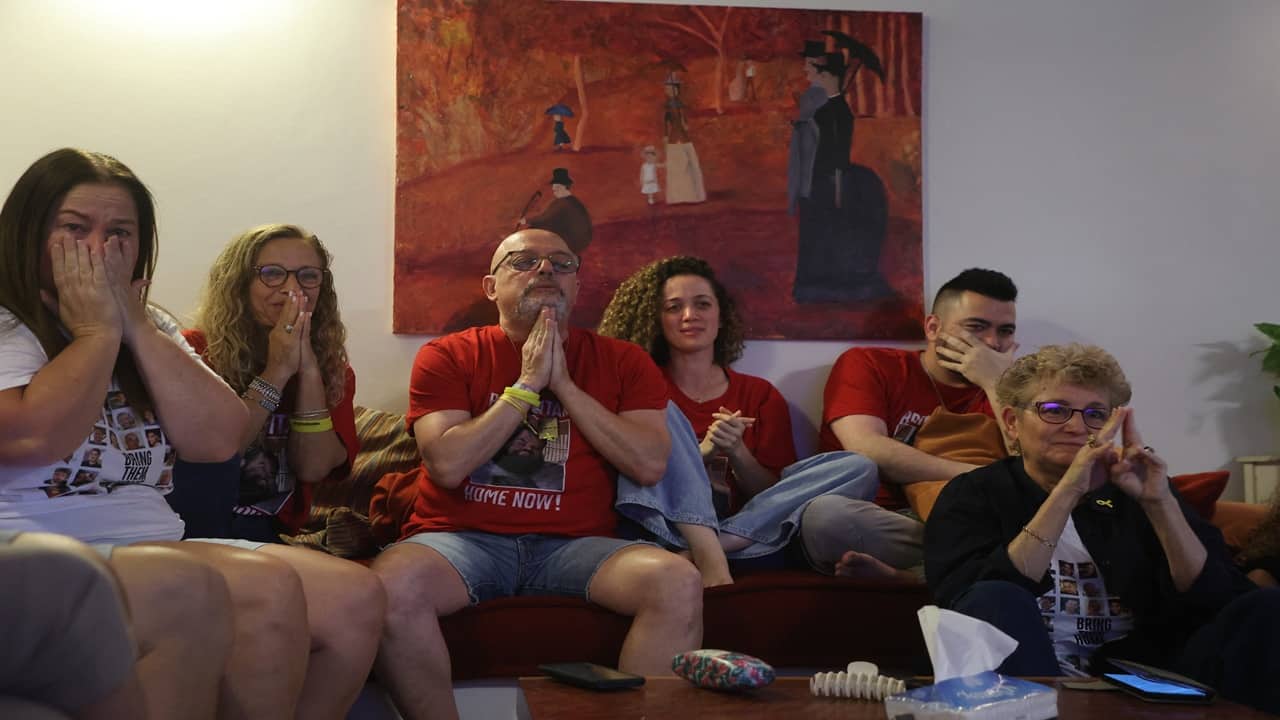 Family and friends of Israeli hostage Eitan Horn celebrate as they wait for his release at their house in the central Israeli city of Rosh Haayin on Monday. Prime Minister Benjamin Netanyahu and his wife Sara prepared handwritten notes and reception kits for the returning hostages, containing clothing, laptops, cellphones, tablets, and other personal items.