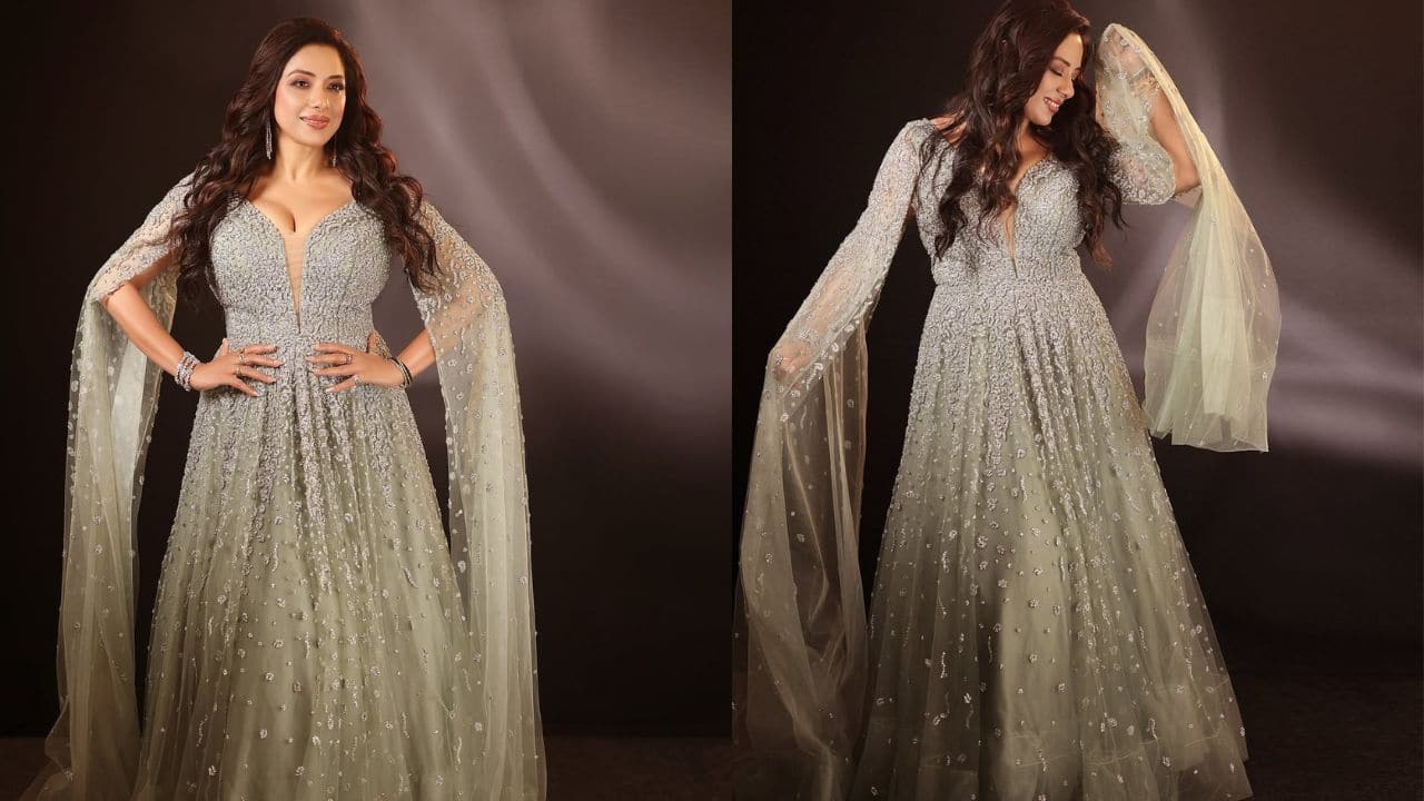 Rupali Ganguly For a party night, you can go shining like a star in an outfit like Rupali has worn. A silver shimmery gown with hair styled into loose curls and a pop of pink with makeup highlight your cheekbones, you sure will look like a doll.