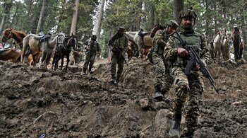 File Photo - Indian soldiers trek back after a search operation around Baisaran meadow in the aftermath of an attack in Pahalgam on April 23, 2025. (Photo by TAUSEEF MUSTAFA / AFP)