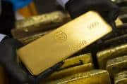 Gold rises to record on Fed rate-cut signal, US-China tensions