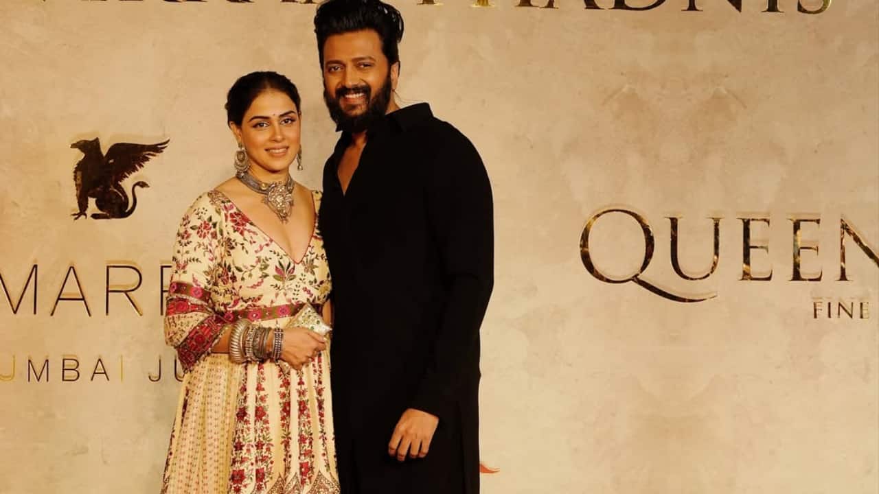 Genelia Deshmukh — Looked regal in cream and crimson embroidered traditional wear, arriving hand-in-hand with husband Riteish Deshmukh.