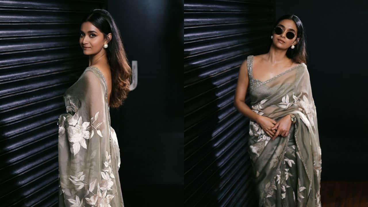 Timeless Charm in Floral Drape This Diwali, shine in a grey organza tissue saree with a shimmering silver border and white floral patterns. Pure elegance in every drape, accessorised with a matching shimmering silver sweetheart-neck blouse, minimal makeup, and basic pearl earrings.