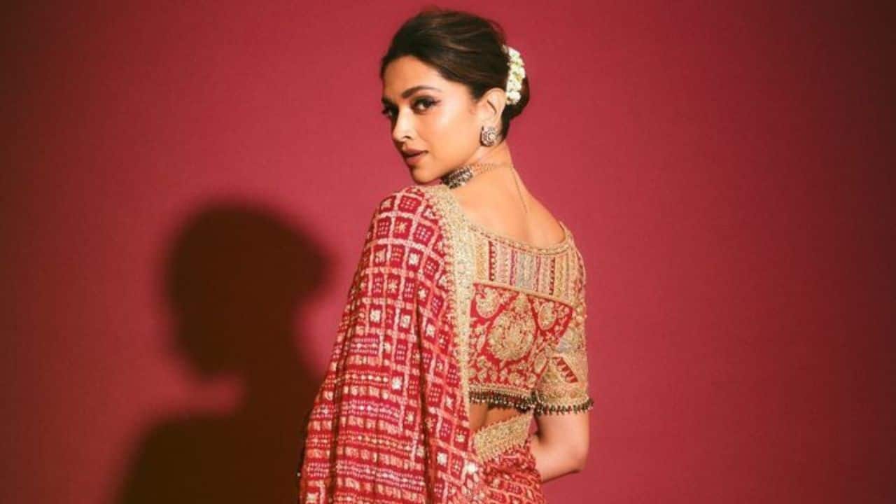 Regal Indian beauty Deepika Padukone showed timeless regal elegance in this stunning ethnic outfit. The rich red traditional attire is perfectly complemented by heavy, exquisite temple-inspired gold jewellery with bold makeup and a sleek, classic hairstyle.