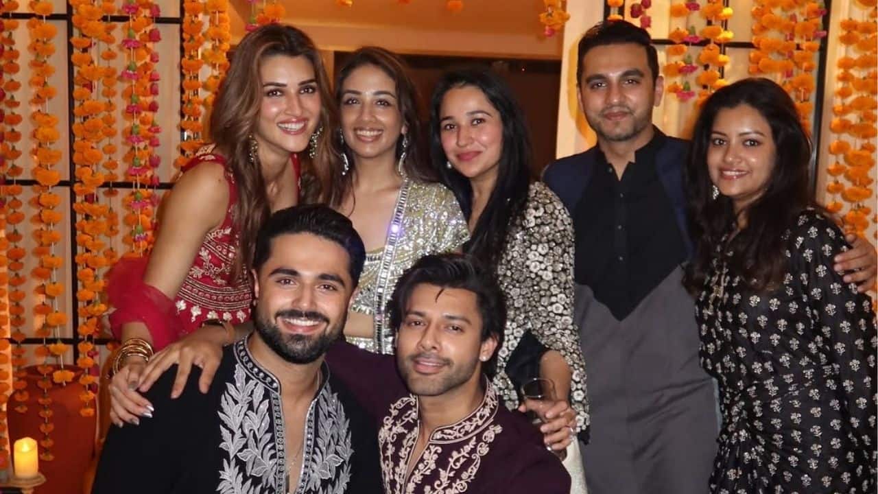 Kriti Sanon is seen celebrating Diwali with her close friends, including her alleged boyfriend Kabir Bahia. Kriti, wearing a festive red-embroidered outfit, is glowing as she joyfully poses in the warm lighting and marigold décor.