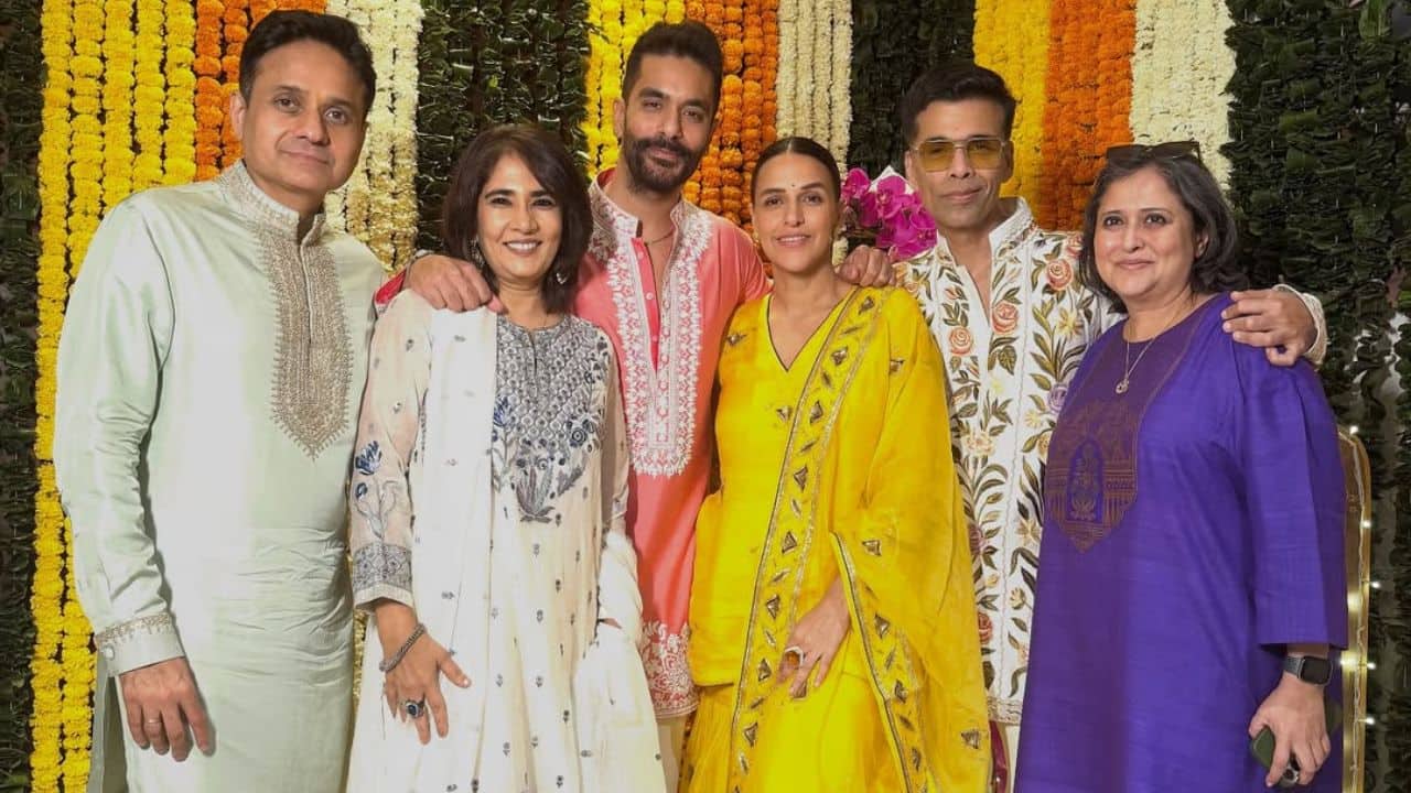 Neha Dhupia and Angad Bedi Neha Dhupia posed with her husband Angad Bedi and close friends during her Diwali celebration, looking elegant in a bright yellow suit. The happy group, which included Karan Johar dressed in a patterned kurta, reflected a lovely Bollywood get-together as they posed against a gorgeous background of marigold flowers.