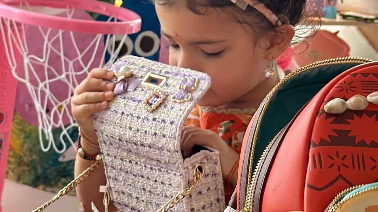 Little Malti is captured exploring her mother’s world — a playful moment with a sparkling purse and festive snacks on the table. Her innocence contrasts beautifully with the luxurious setting, reminding us that Diwali’s true glow lies not in glamour, but in childhood wonder and discovery.
