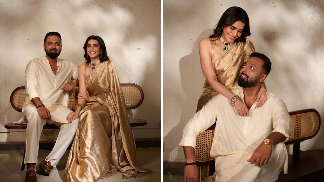 Karishma Tanna and Varun Bangera Karishma lit up the festivities with her gorgeous handwoven gold tissue saree, accessorised beautifully with a choker featuring emeralds. Her husband Varun looked handsome in a luxurious off-white kurta set. (Image: Instagram)