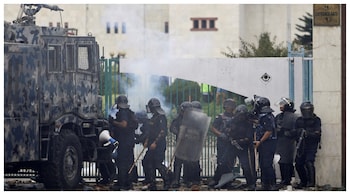 A riot police officer loading his gun while guarding the parliament during the protest against anti-corruption triggered by a social media ban, in Kathmandu. (Courtesy: Reuters photo)