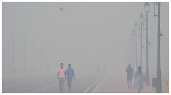 People walking near the India Gate amidst morning smog a day after Diwali in New Delhi. (Courtesy: AP photo)