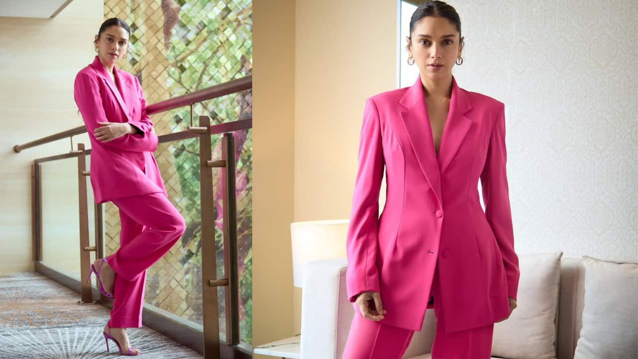 Hot Pink Suit Aditi Rao's hot pink suit and slightly longer coat gave off major western fashion goals. She layered her appearance with carefully chosen modern accessories and wore her hair in a sleek ponytail to maintain a strong, powerful appearance.