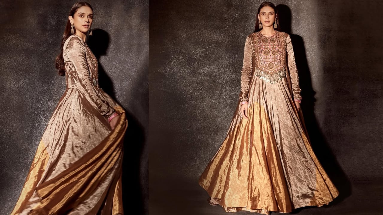 Bronze Metallic Outfit Aditi exuded royal charm while wearing a full-length bronze metallic dress that featured intricate embroidery on the torso and neckline. The actress simply accessorised her look with heavy jhumkas, allowing the outfit's elegance to speak for itself.