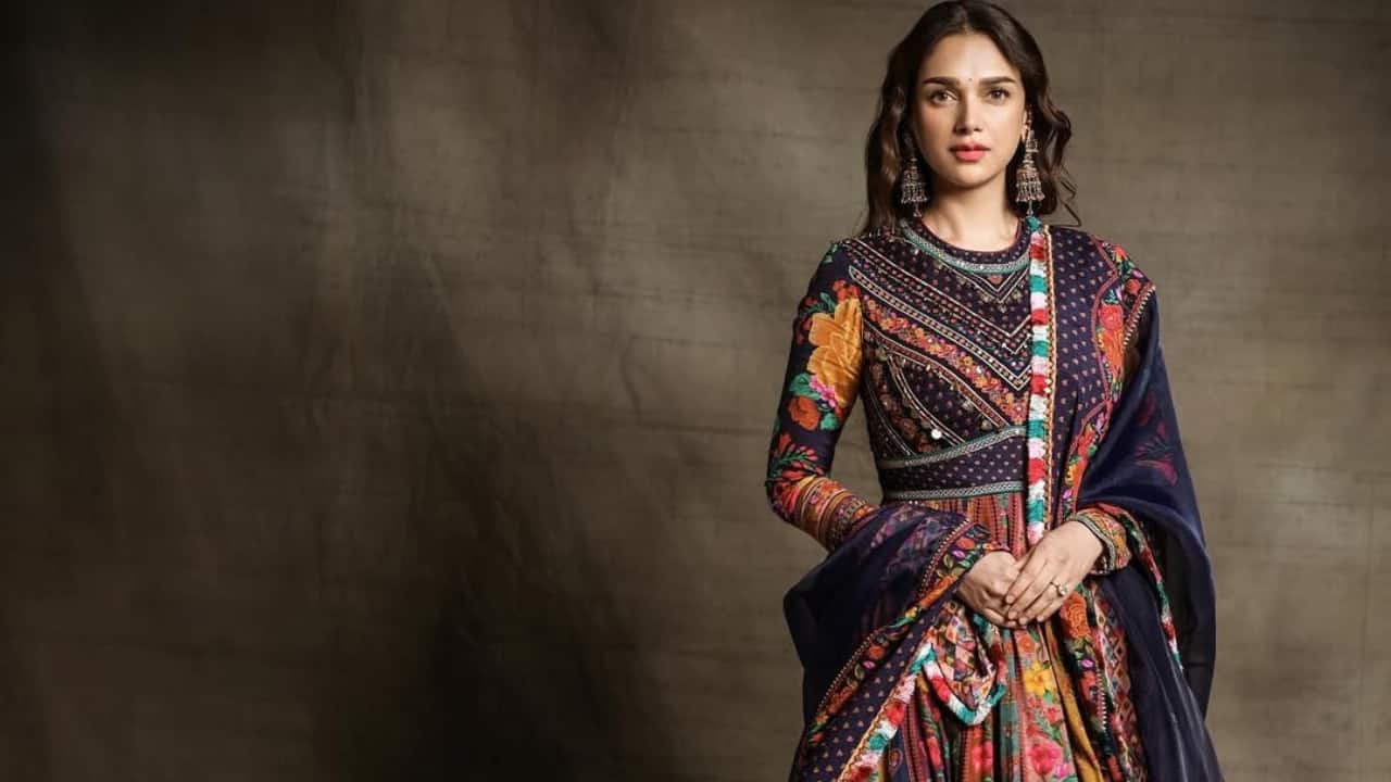 Multi-coloured Anarkali Aditi blossomed in a full-length, multicoloured anarkali with intricate embroidery around the torso and floral prints all over. She just wore her hair in thick curls and accessorised her ensemble with chunky rings and earrings.