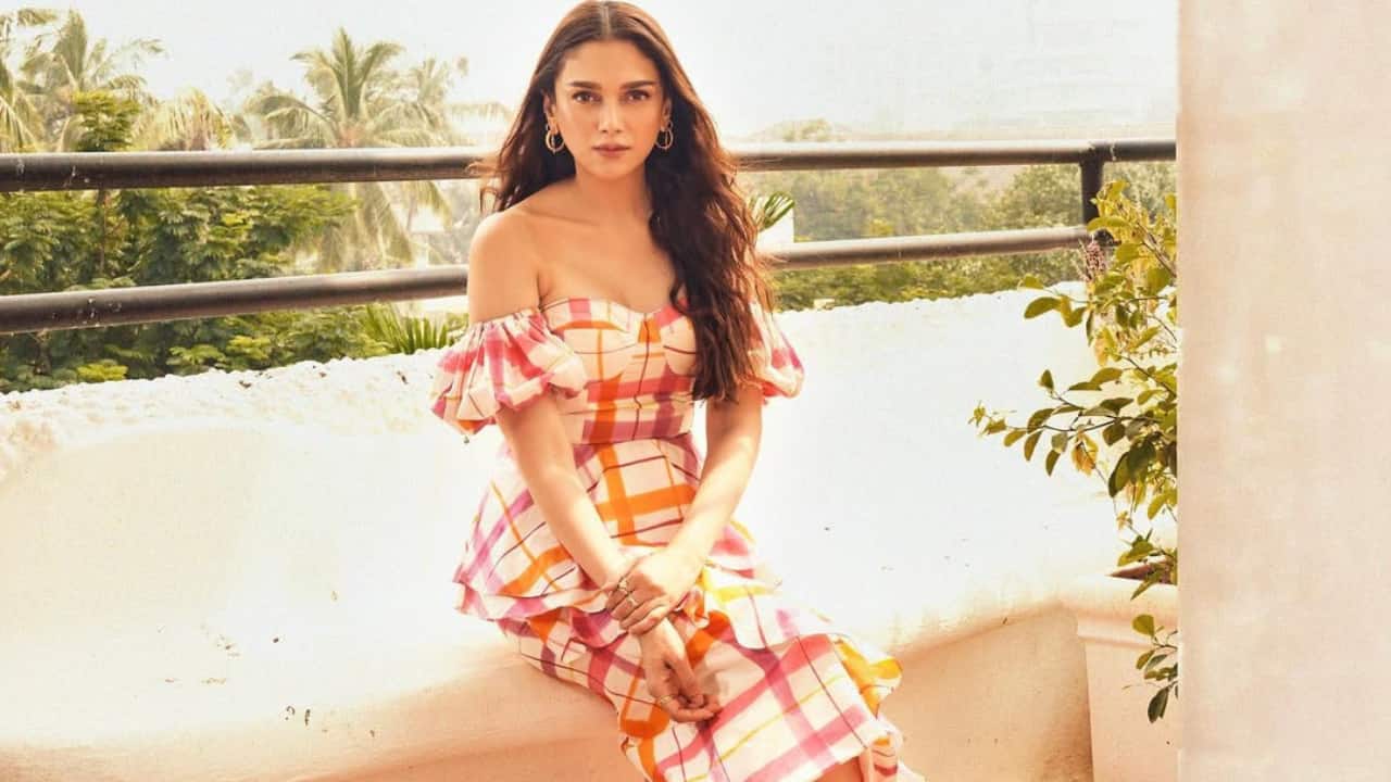Checked Skirt Dress Wearing a skirt dress with checks in shades of pink, yellow, and orange, Aditi looked stunning as ever. By wearing modern jewellery and wearing her hair in soft waves, she allowed the ensemble to take centre stage.