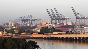 Shipping containers are seen stacked on a ship at a sea port in Karachi on April 6, 2023. (Photo by Aamir QURESHI / AFP)