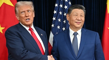 US President Donald Trump (L) and China's President Xi Jinping shake hands in Busan on October 30, 2025. (AFP)