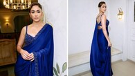 <strong>Cocktail-ready</strong><br />She is truly breathtaking in the blue satin saree featuring sequins and crystal embroidery. It’s clubbed with a sleeveless jewelled blouse with crystal embellishments. Sleek earrings, rings, and a side-swept bun complete her look.