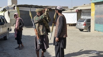 Taliban security personnel carry a rocket-propelled grenade (RPG) near the border, as clashes take place between Taliban security personnel and Pakistani border forces, in the Spin Boldak district of Kandahar Province on October 15,2025. (Photo by Sanaullah SEIAM / AFP)