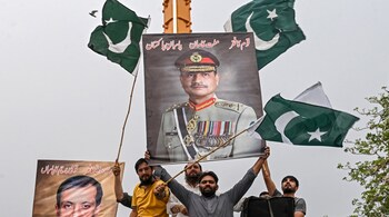 Demonstrators carrying posters with portraits of Pakistan's Chief of Army Staff General Syed Asim Munir shout slogans as they participate in an anti-India protest in Lahore on May 11, 2025. (Photo by Arif ALI / AFP)