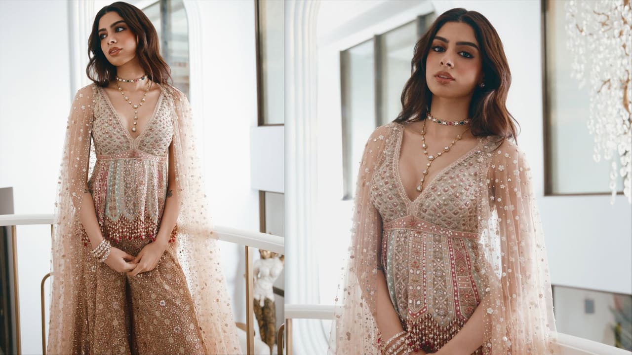 <strong>Embellished look</strong><br />Khushi Kapoor looked stunning in this heavily embroidered, exquisite ethnic ensemble. She sported a heavily embellished short kurta with intricate beadwork, sequins, and possibly thread embroidery, paired with a matching pants. She completed her traditional wear with a sheer, floor-length cape.