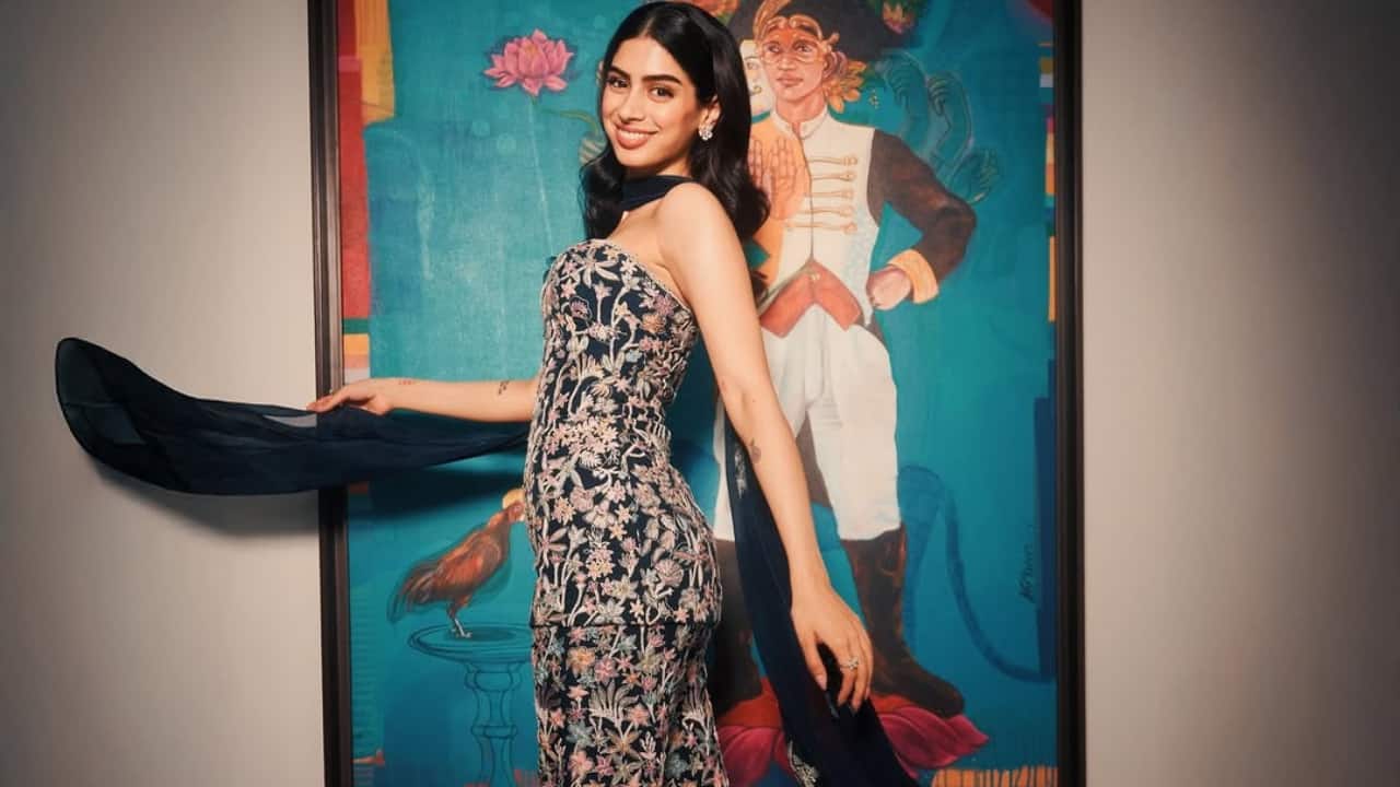 <strong>Floral charm</strong><br />Khushi is wearing a delicate, floral, strapless navy-blue dress with oversized prints. The fitted silhouette of the dress is both chic and playful, capturing a romantic, festive mood. Accessorising the ensemble with a dark blue dupatta and charming smile, the actress dazzles in this look.