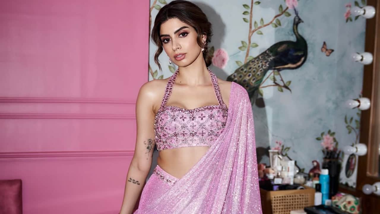 <strong>Flamingo pink saree</strong><br />Khushi looks stunning in this vibrant flamingo pink sequined saree, radiating a glamorous 'Desi Barbie' aesthetic. The modern sequin work contrasts beautifully with the traditional drape, establishing her as a true Gen-Z fashion icon. She pairs this dazzling ensemble with minimal jewellery and soft makeup, letting the shimmering fabric take the spotlight.