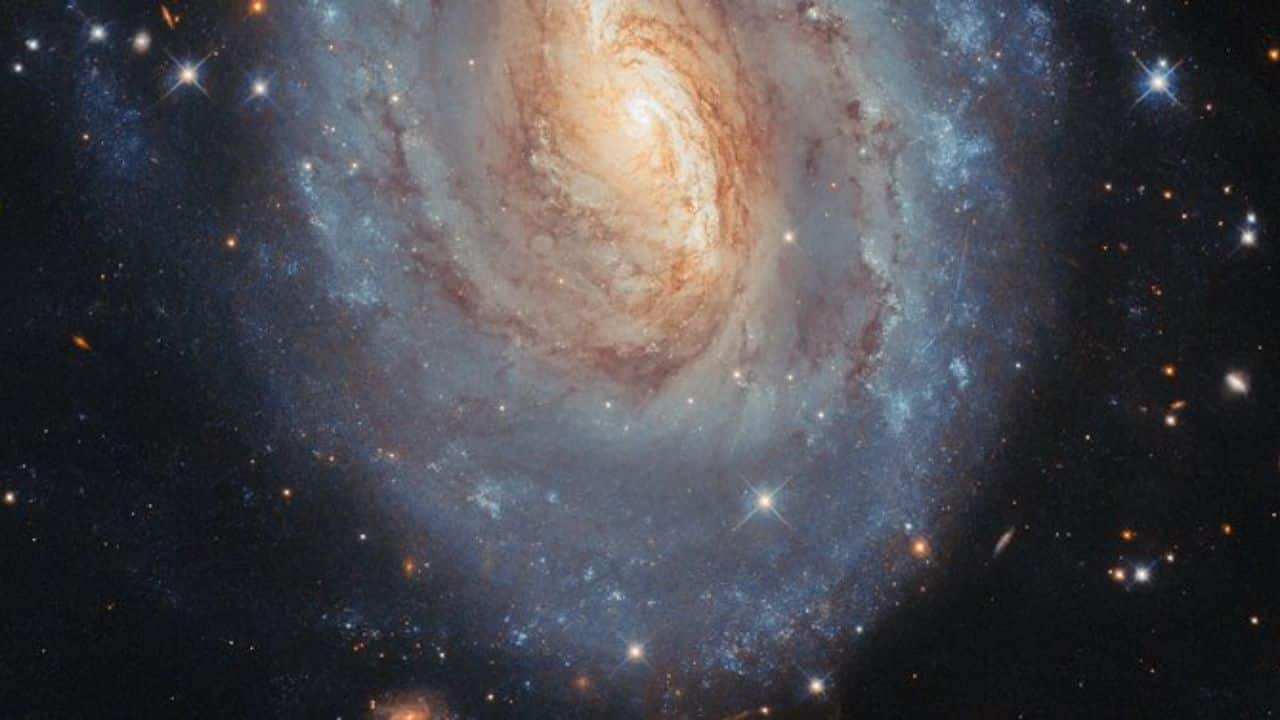 Hubble’s image of spiral galaxy NGC 6000, located 102 million light-years away in Scorpius, reveals stars of all ages, past supernovae, and even an asteroid crossing its view. (Image: ESA)