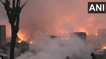 Firefighting operations continue, to douse the fire which broke out at slum area near Rithala metro station (ANI)