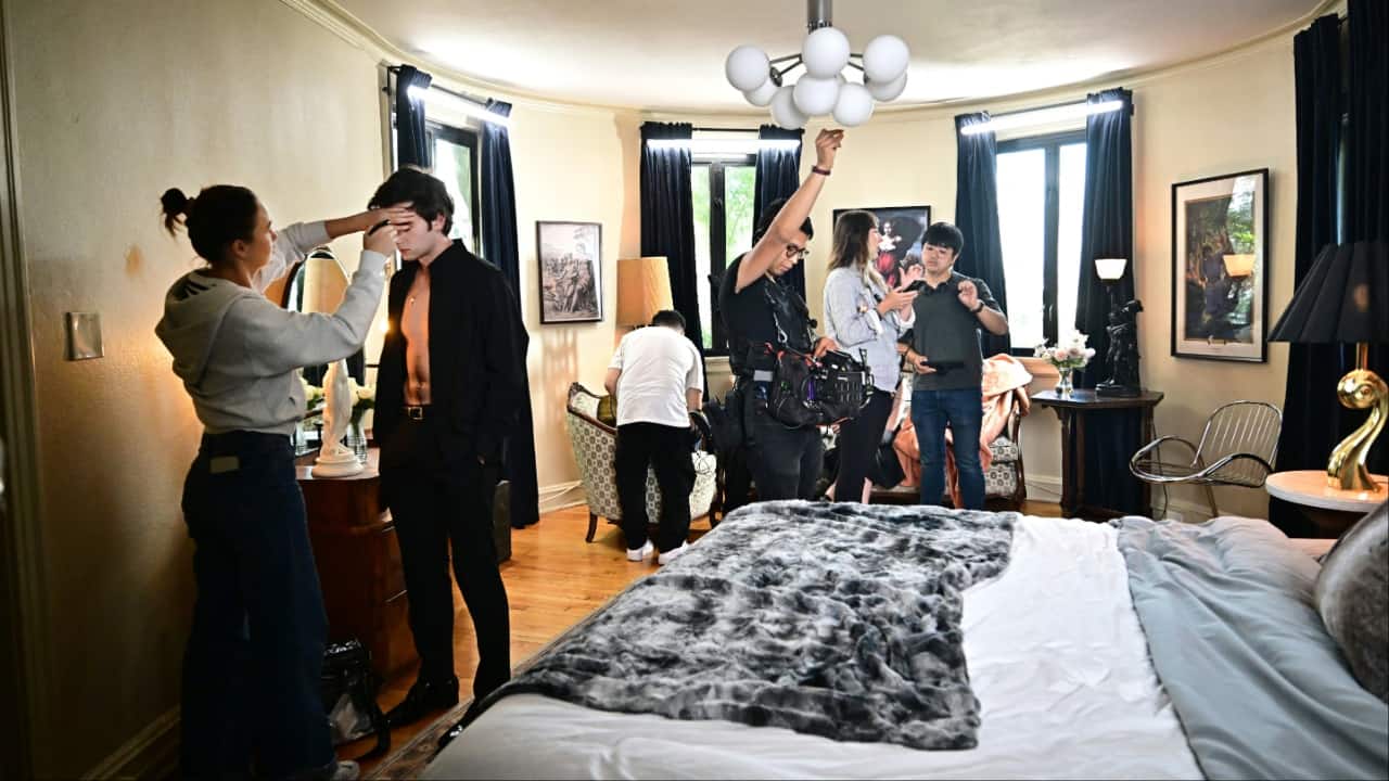 Ukraine-born actor Zachary Shadrin (2nd L) gets makeup done as Chinese director Weiyang Li (R) discusses a scene while filming the vertical drama "Love Through All Seasons" at the Wrensmoor Castle, in Alhambra, California. (Image credit: AFP)